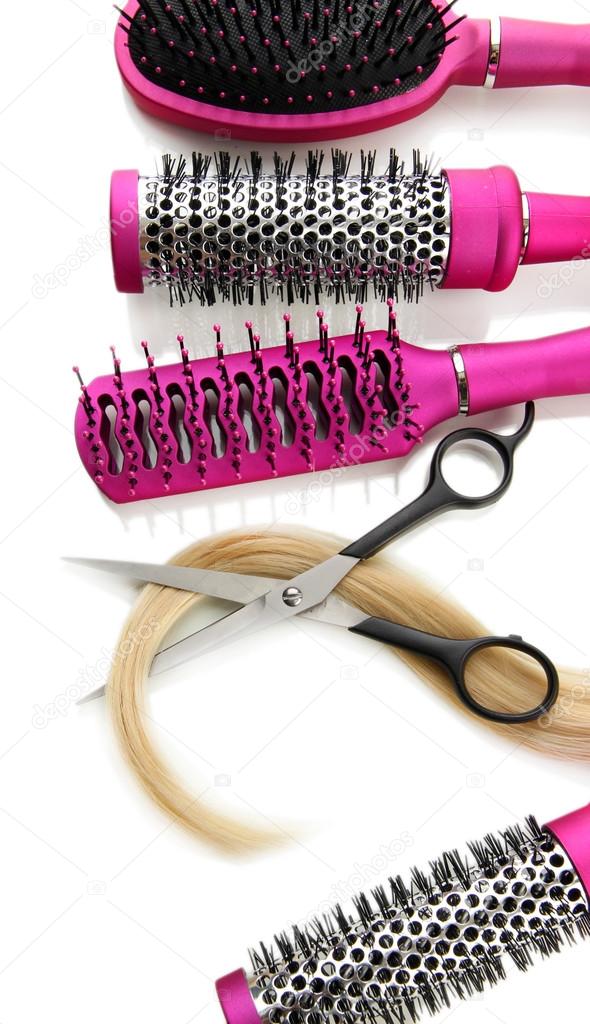 Comb brushes, hair and cutting shears, isolated on white