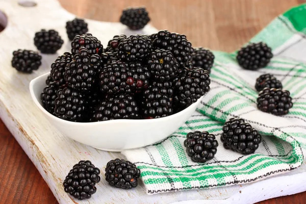 Sweet blackberry in bowl on wooden table — Stock Photo, Image