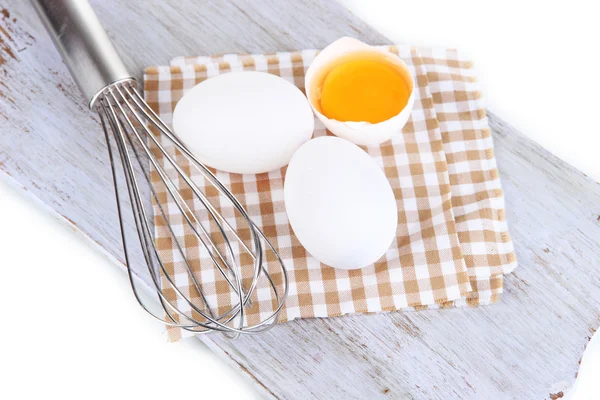 Corolla and eggs on wooden board isolated on white — Stock Photo, Image