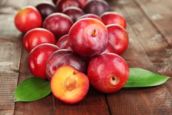 Ripe plums on wooden table close-up — Stock Photo, Image