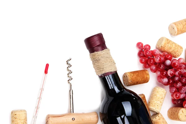 Bottle of wine, grapes and corks, isolated on white — Stock Photo, Image