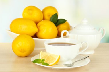 Arka planda limonlu bir fincan çay.