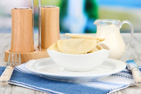 Tasty dumplings on white plate, on bright background — Stock Photo, Image