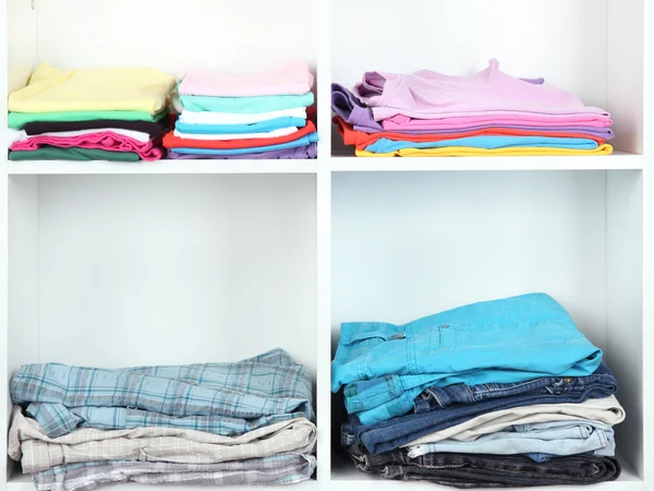 Clothes neatly folded on shelves — Stock Photo, Image