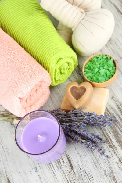 Still life with lavender candle, soap, massage balls, soap and fresh lavender, on wooden background — Stock Photo, Image