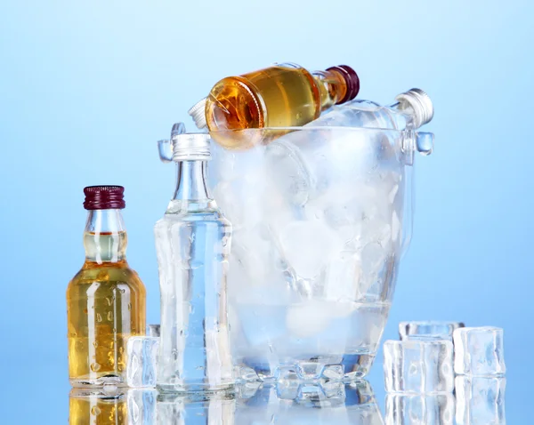 Mini Bar şişe renkli arka plan üzerinde buz küpleri ile kova — Stok fotoğraf