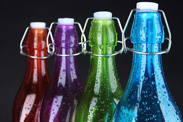 Colorful bottles on black background — Stock Photo, Image