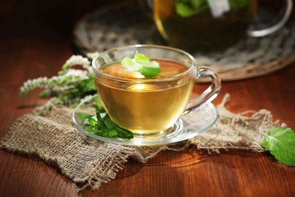 Kupa és a teáskannát, fából készült asztal friss menta virág gyógynövény tea — Stock Fotó
