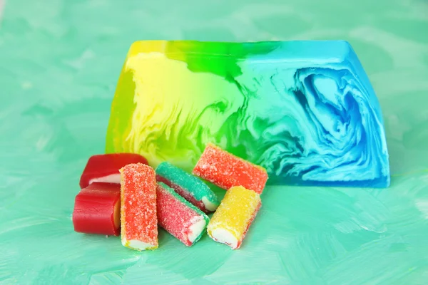 Piece of handmade soap with candy flavor, on bright background