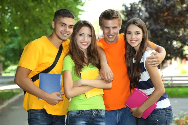 Happy group of young students standing in park Stock Picture