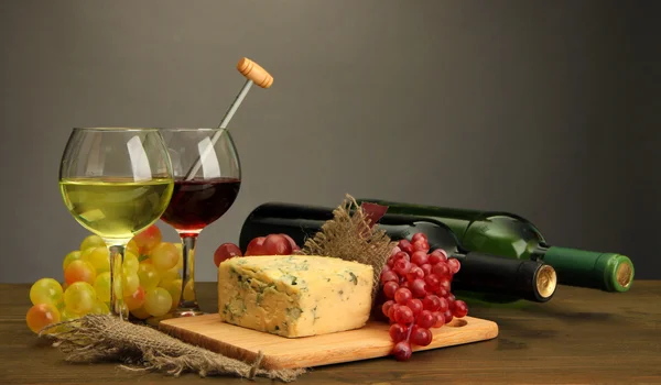 Composición con vino, queso azul y uva sobre mesa de madera, sobre fondo gris —  Fotos de Stock