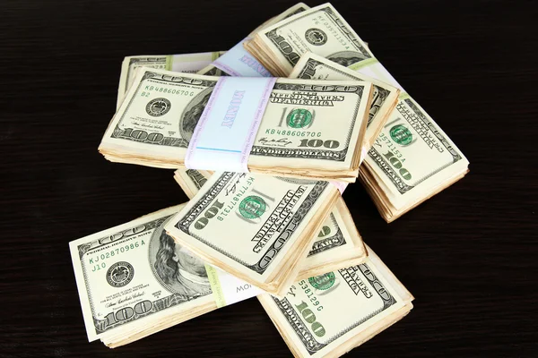 Stacks of money on wooden table — Stock Photo, Image