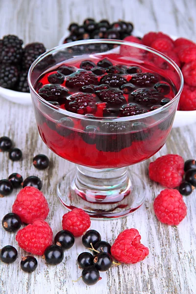 Jelly with fresh berries on wooden table close up — Stock Photo, Image