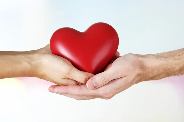 Heart in hands on light background — Stock Photo, Image