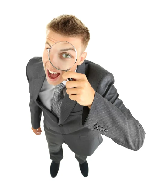 Young businessman looking through magnifying glass isolated on white — Stock Photo, Image