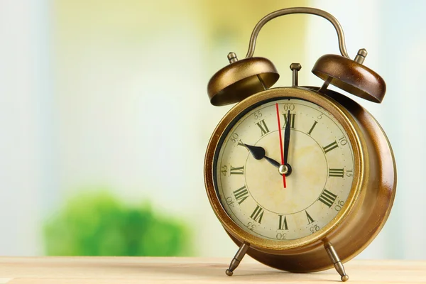 Old alarm clock on bright background — Stock Photo, Image