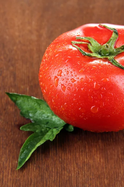 Fresh tomato on wooden background — Stock Photo, Image