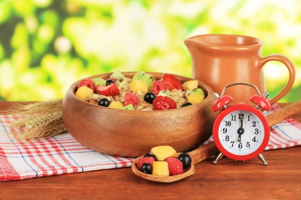 Oatmeal with fruits on table on bright background — Stock Photo, Image