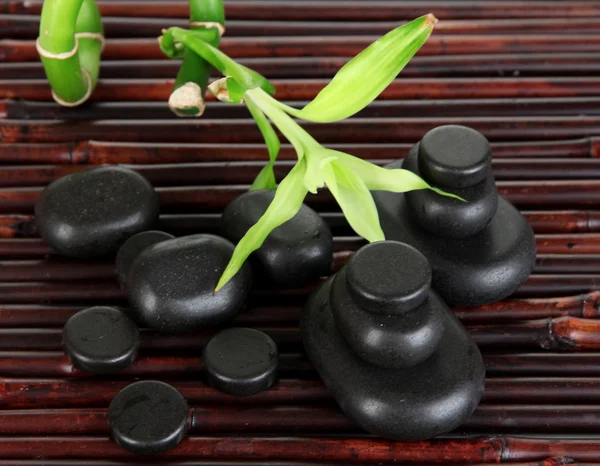 Spa stones and bamboo on bamboo mat background — Stock Photo, Image