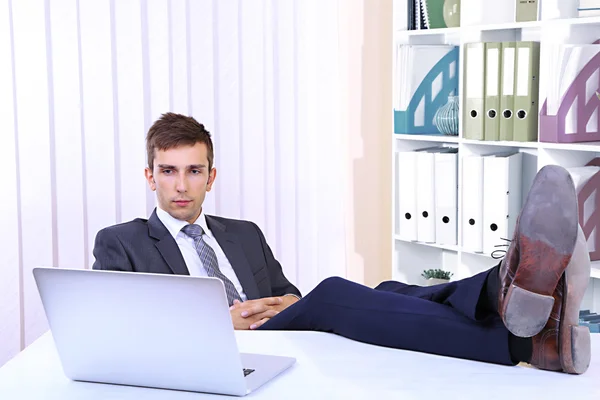 Empresario descansando en su oficina con sus zapatos en la mesa — Foto de Stock