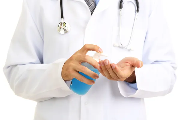 Médico usando dispensador de desinfectante — Foto de Stock