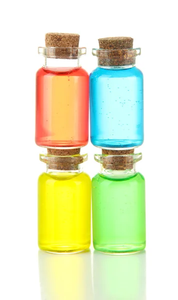 Garrafas com líquidos coloridos isolados em branco — Fotografia de Stock