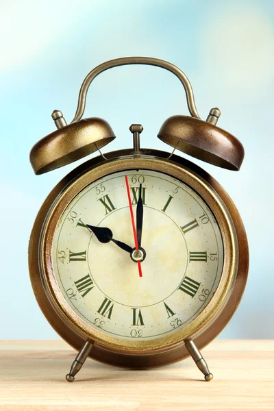 Old alarm clock on bright background Stock Photo