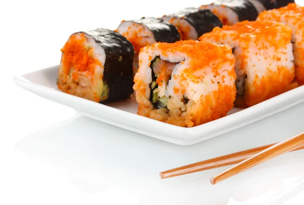 Heerlijke sushi op plaat en eetstokjes geïsoleerd op wit — Stockfoto