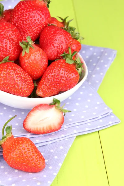 Fraise fraîche dans un bol sur fond de bois vert — Photo