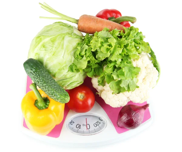 Färska grönsaker på skalor på grå bakgrund — Stockfoto
