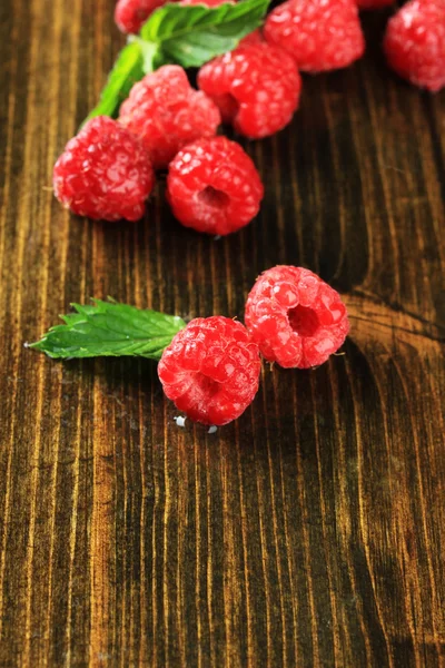 Framboises sucrées mûres sur fond de bois — Photo