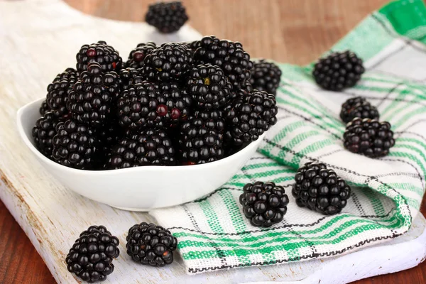 Zoete blackberry in kom op houten tafel — Stockfoto