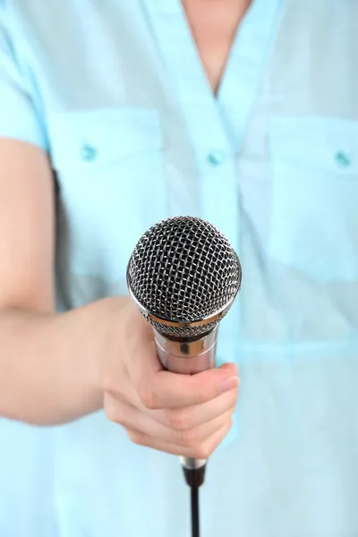 Female with microphone close-up background — Stock Photo, Image