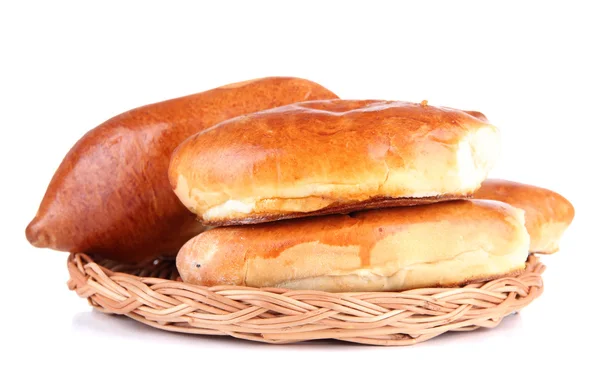 Fresh baked pasties on wicker plate, isolated on white — Stock Photo, Image