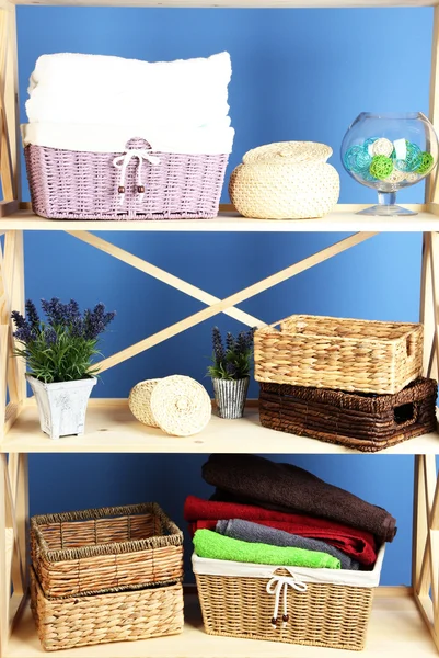 Hermosos estantes blancos con diferentes objetos relacionados con el hogar, en el fondo de la pared de color —  Fotos de Stock
