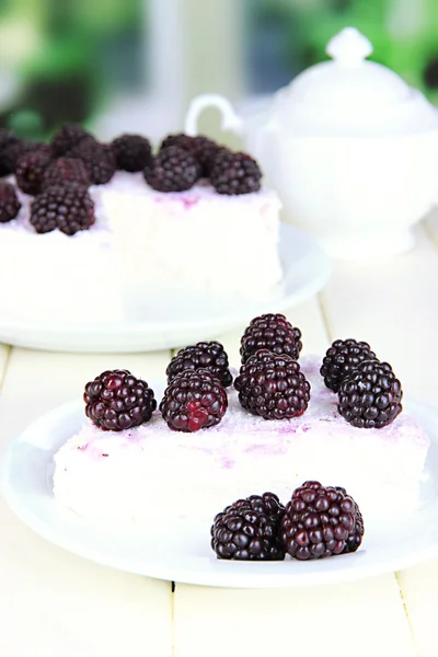 Cheesecake with fresh berries on white plate on wooden table — Stock Photo, Image