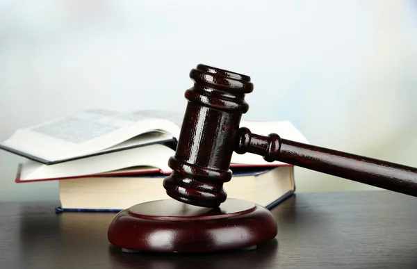 Gavel and books on table on light background — Stock Photo, Image