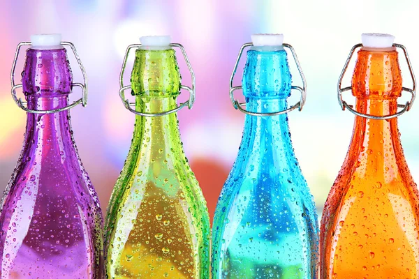 Барвисті пляшки на яскравому фоні — стокове фото