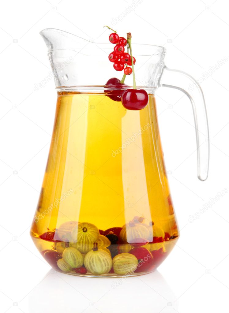 Glass pitcher of compote with different summer berries isolated on white