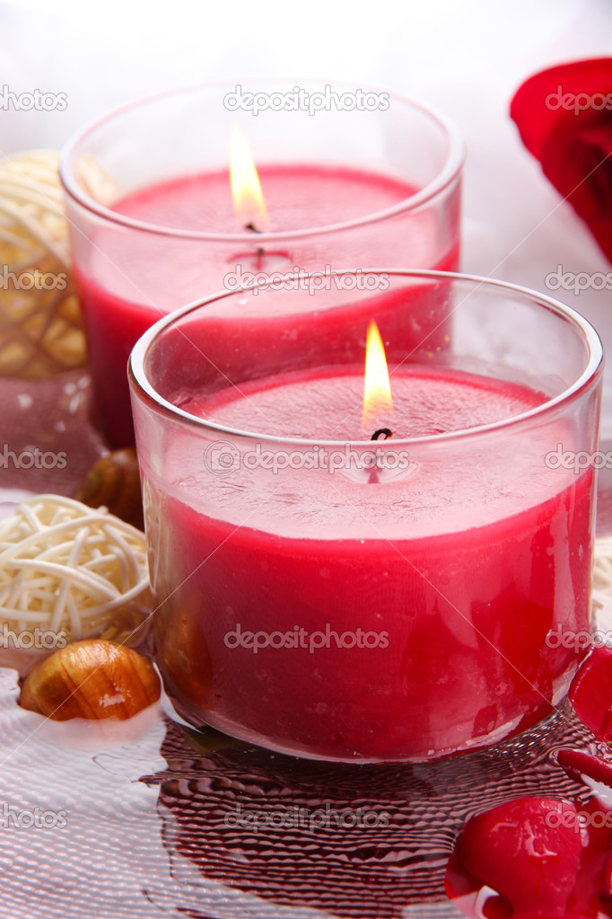 Beautiful red candles with flower petals in water ⬇ Stock Photo, Image