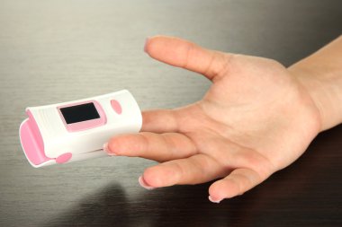 pulse oksimetre ahşap zemin üzerinde nabız ve oksijen oranı düzeylerini ölçmek için kullanılan