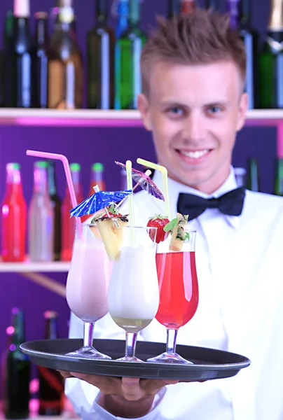 Portrait of handsome barman with different cocktails cocktail, at bar — Stock Photo, Image