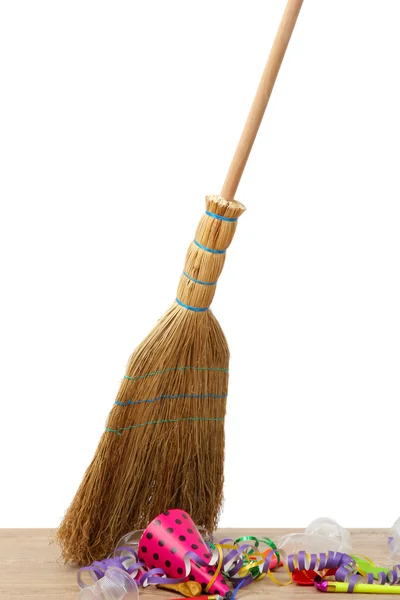 Broom sweep the trash after a party on white background close-up — Stock Photo, Image