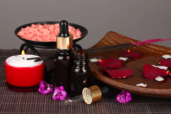 Spa composition with aroma oils on table on gray background — Stock Photo, Image