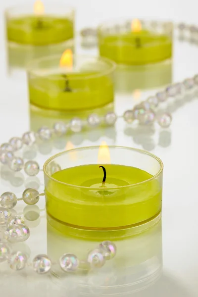 Lighted candles with beads close up — Stock Photo, Image