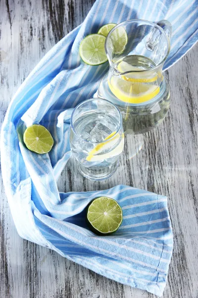 Glas tillbringare med vatten och glas på träbord närbild — Stockfoto