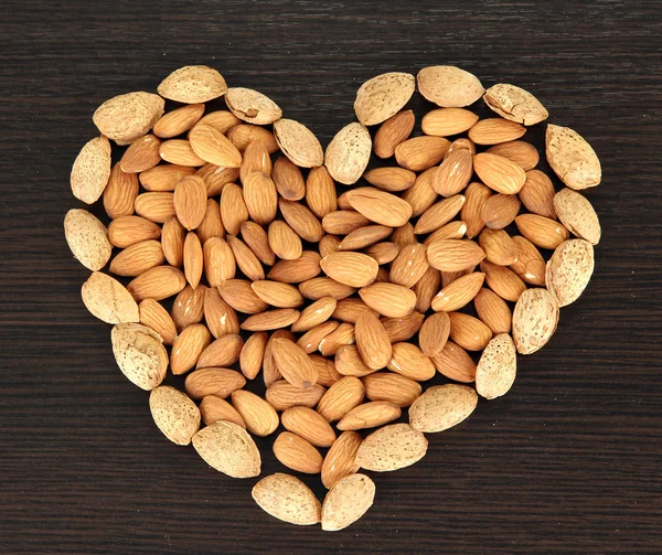 Almond on dark wooden background — Stock Photo, Image