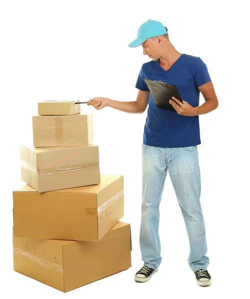 Young delivery man with parcels and clipboard, isolated on white — Stock Photo, Image