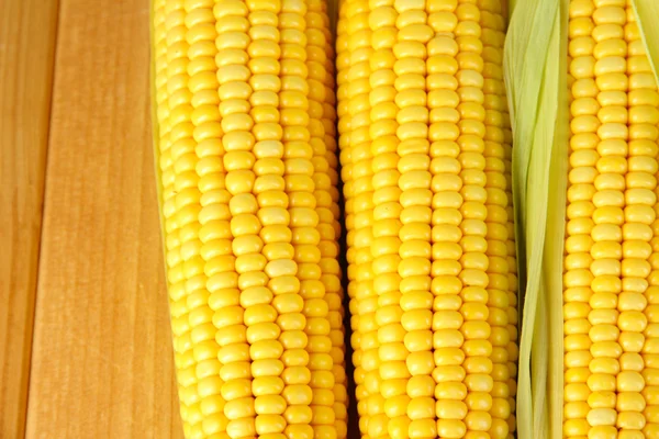 Crude corns on wooden table — Stock Photo, Image