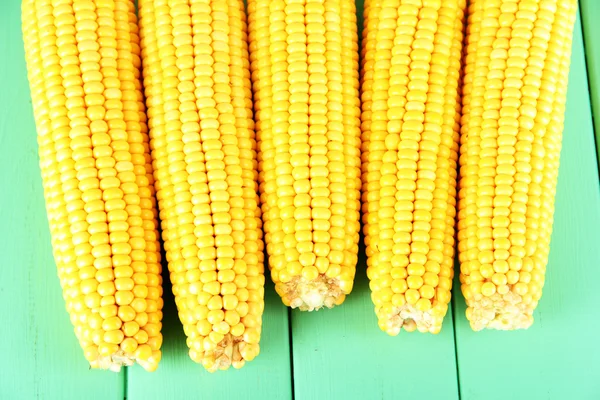 Crude corns on wooden table — Stock Photo, Image